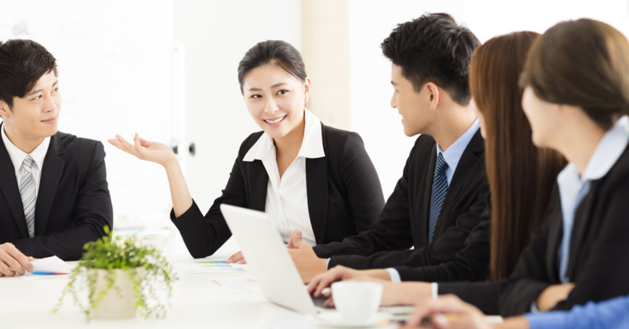 Japanese workers at a meeting look happy and more refreshed, an outcome of a 4 day work week.