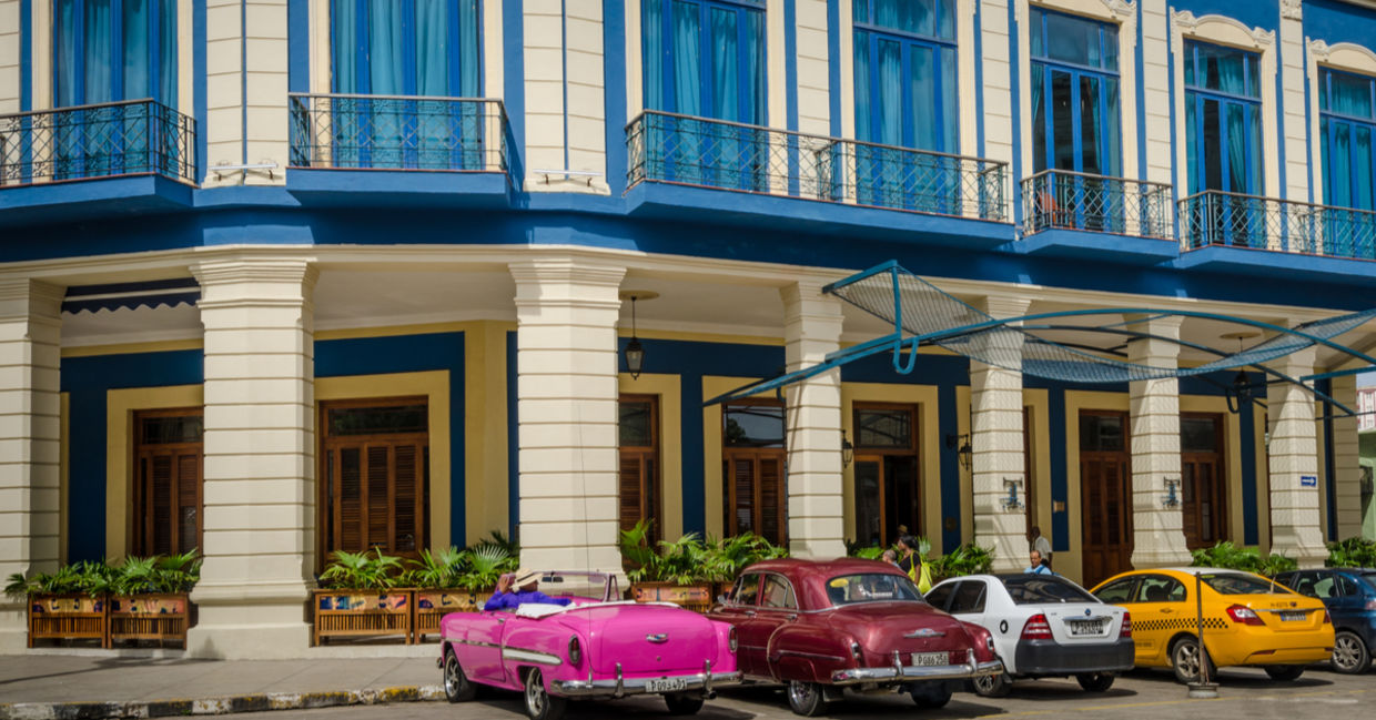 Classic cars are among the taxis waiting for passengers outside of Cuba’s Hotel Telégrafo
