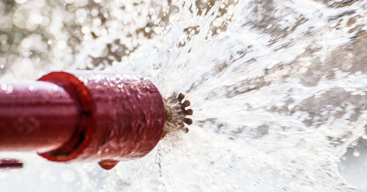 Sprinkler head shooting our fire-suppression materials.