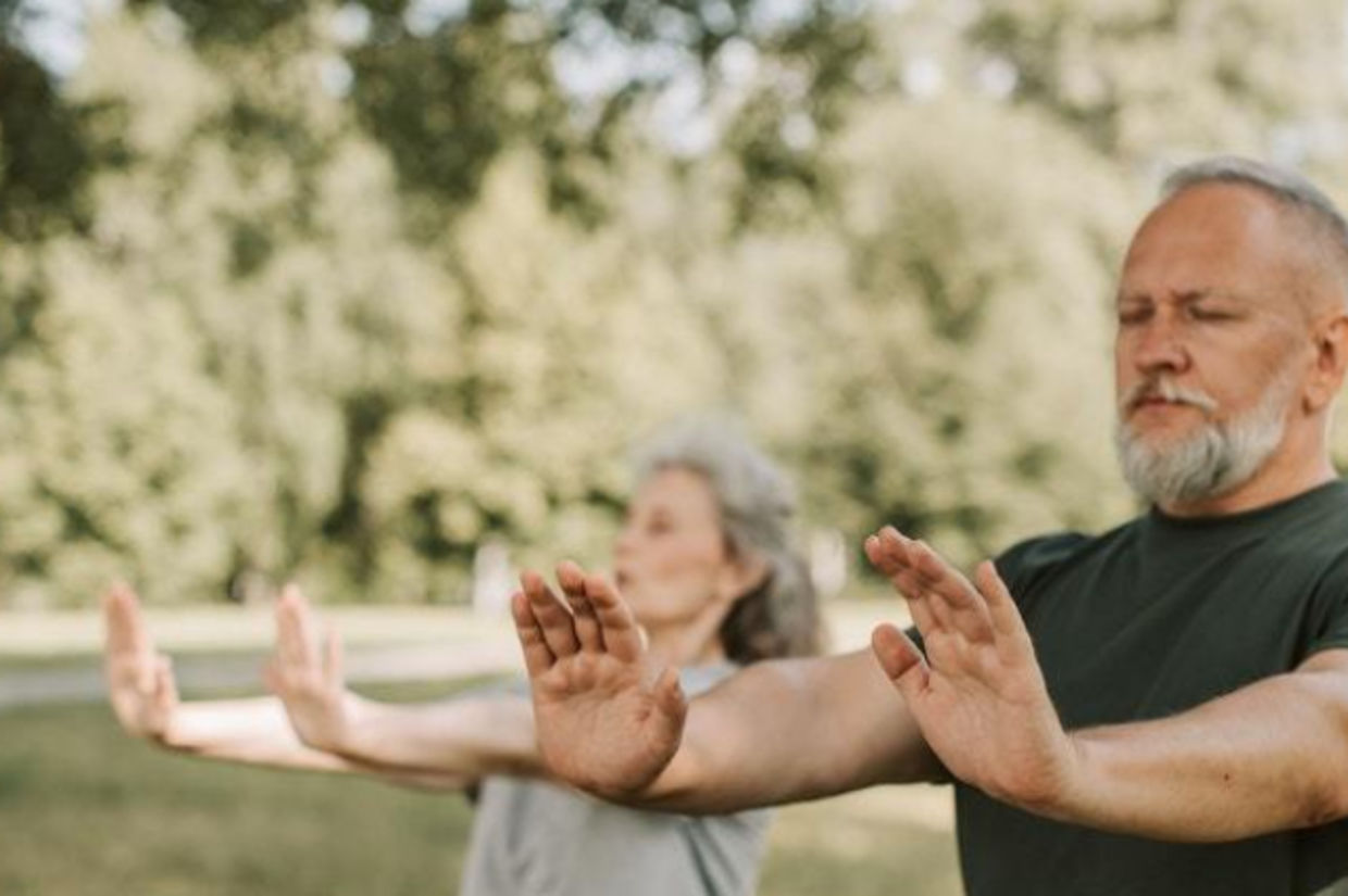 Seniors practicing kemetic yoga movements.