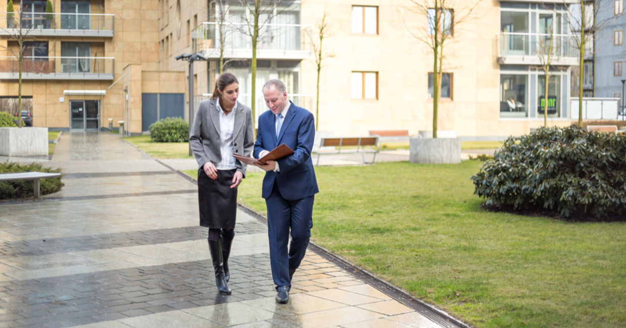Two business people walking and discussing outside the office