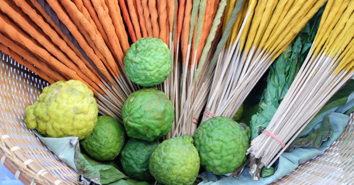 Bergamot fruit and colorful incense sticks.