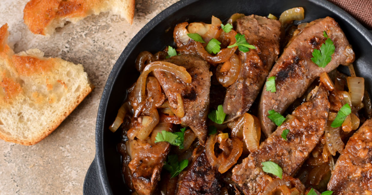 A plate of fried liver with onions.