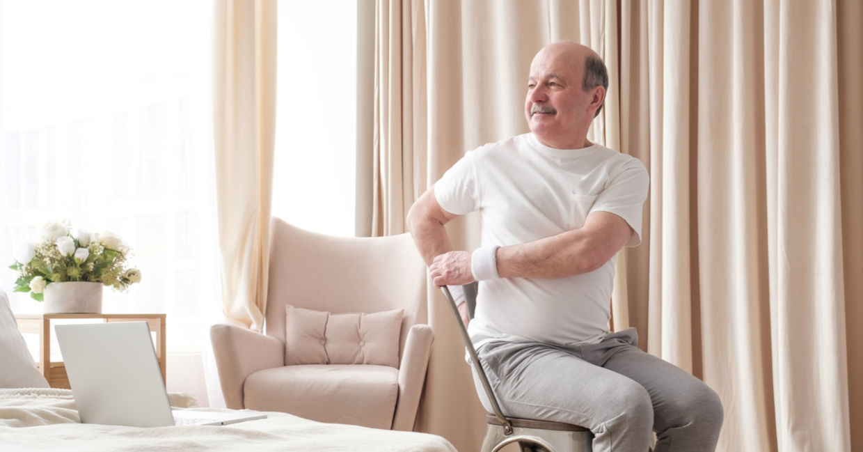 A man sits in a chair and twists, activating the vagus nerve in his torso.