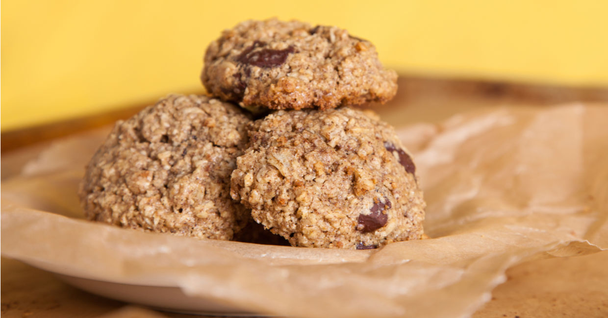 Oven-fresh oatmeal chocolate chip cookies on unbleached parchment paper.