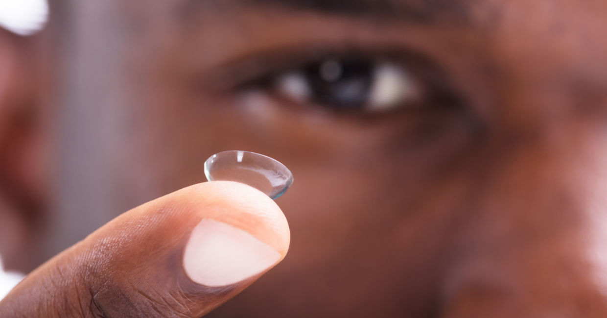 Man removing contacts before swimming.