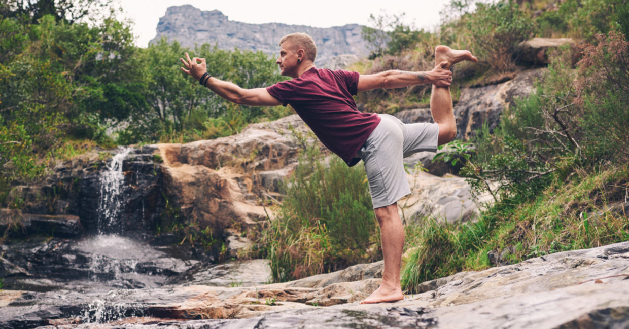 Man performing the dancers yoga pose.