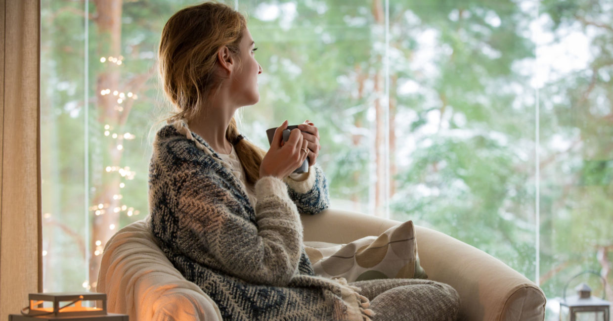 Woman keeping warm in the winter with a warm shawl.