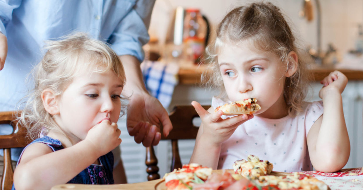 Kids enjoying homemade pizza.