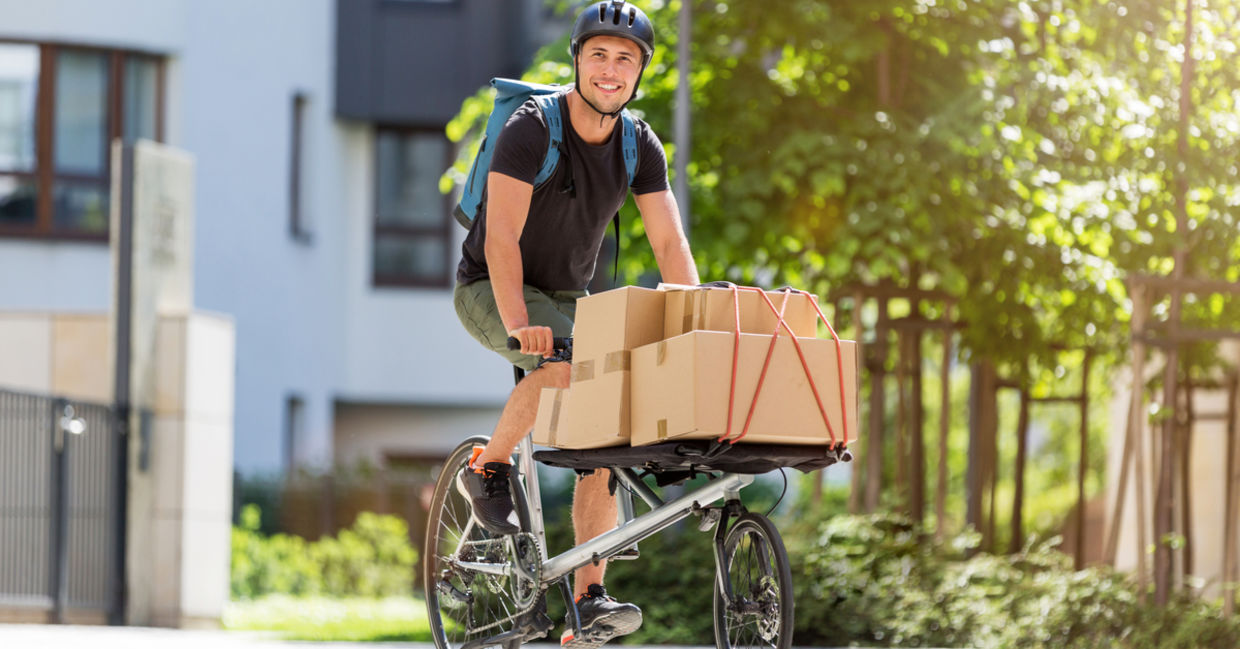 Bicycle messenger making a delivery on a cargo bike