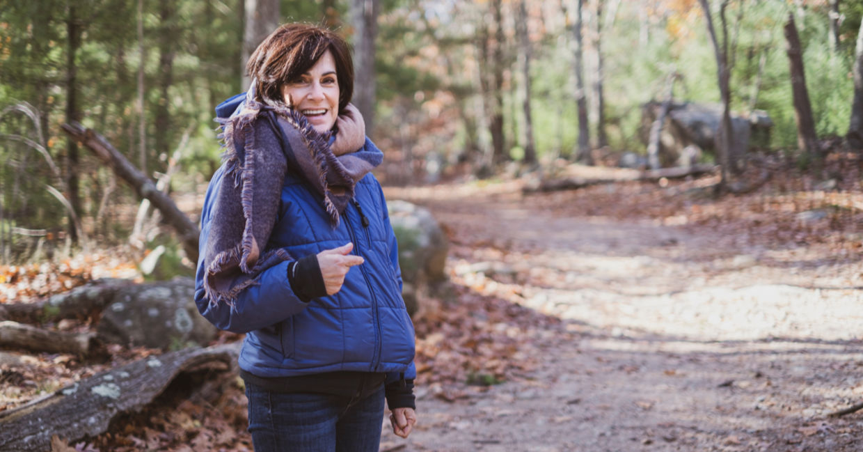 Woman staying active on a winter hike in the woods