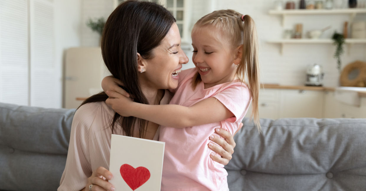 Cheerful mother and daughter hugging each other