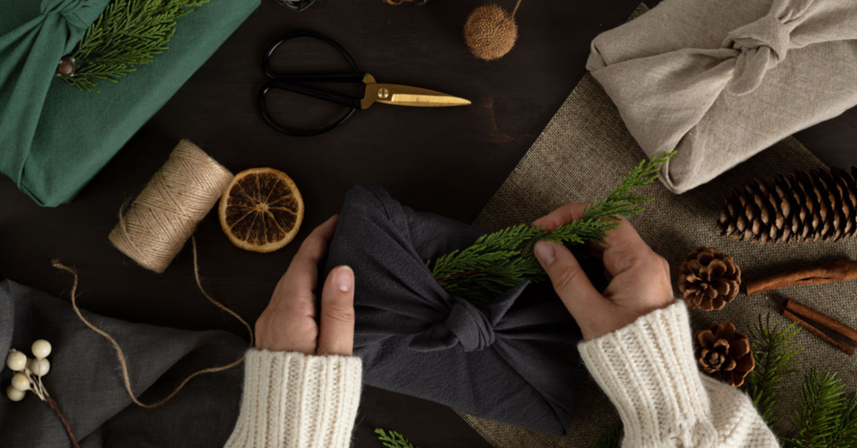 A woman wraps her presents furoshiki style, a nice environmentally-friendly option.