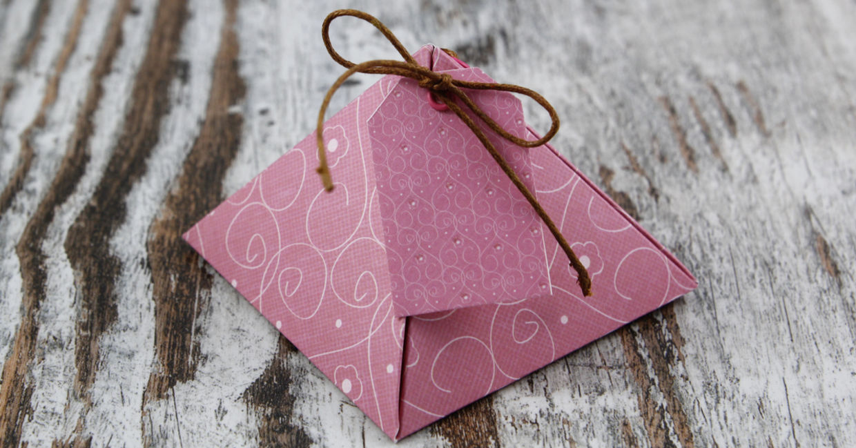 A handmade pyramid gift box tied with twine.