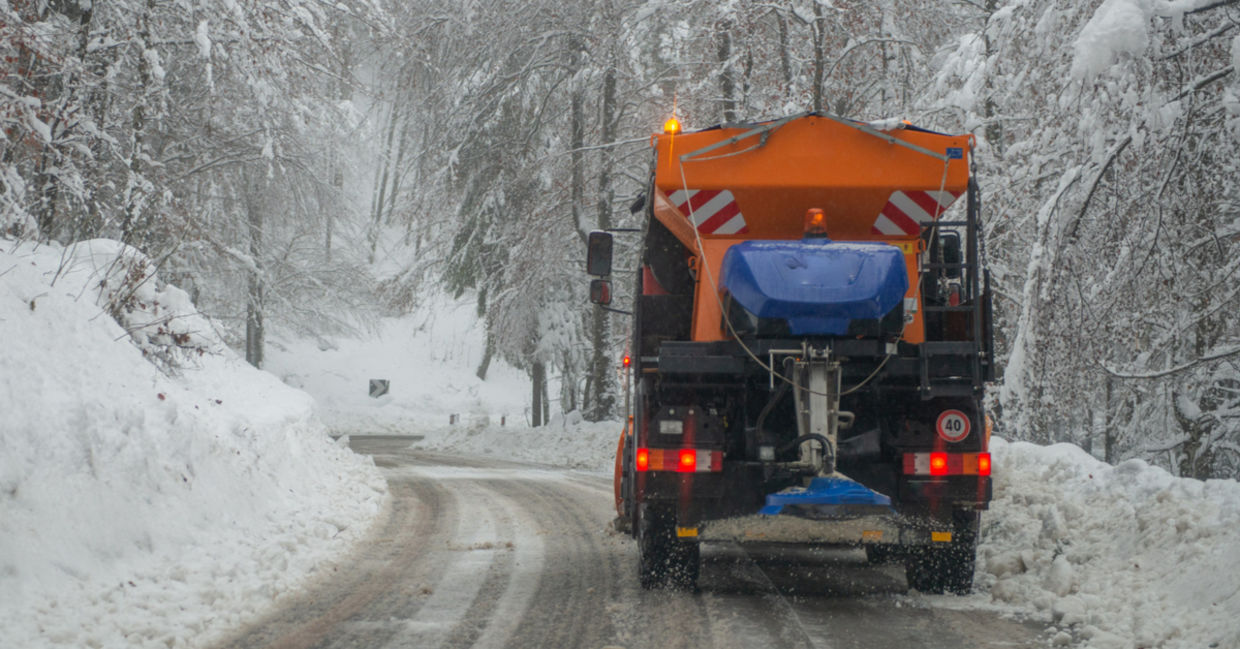 DE-icing truck on a snow-covered road.