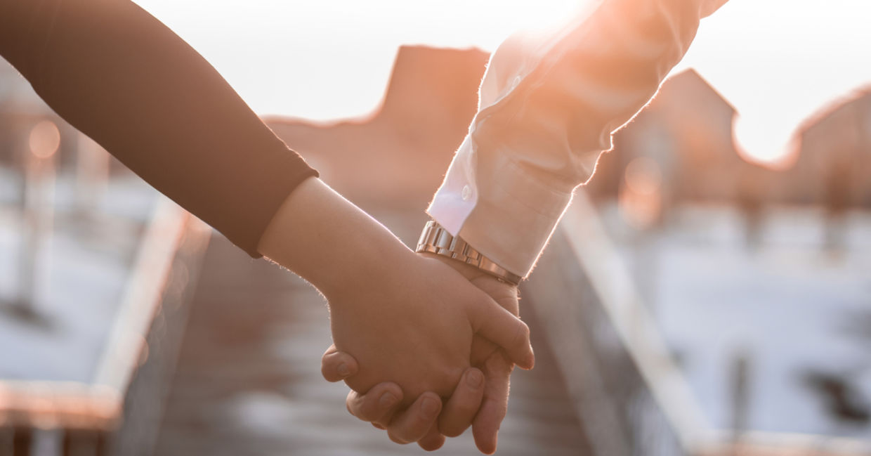 A couple holding hands.