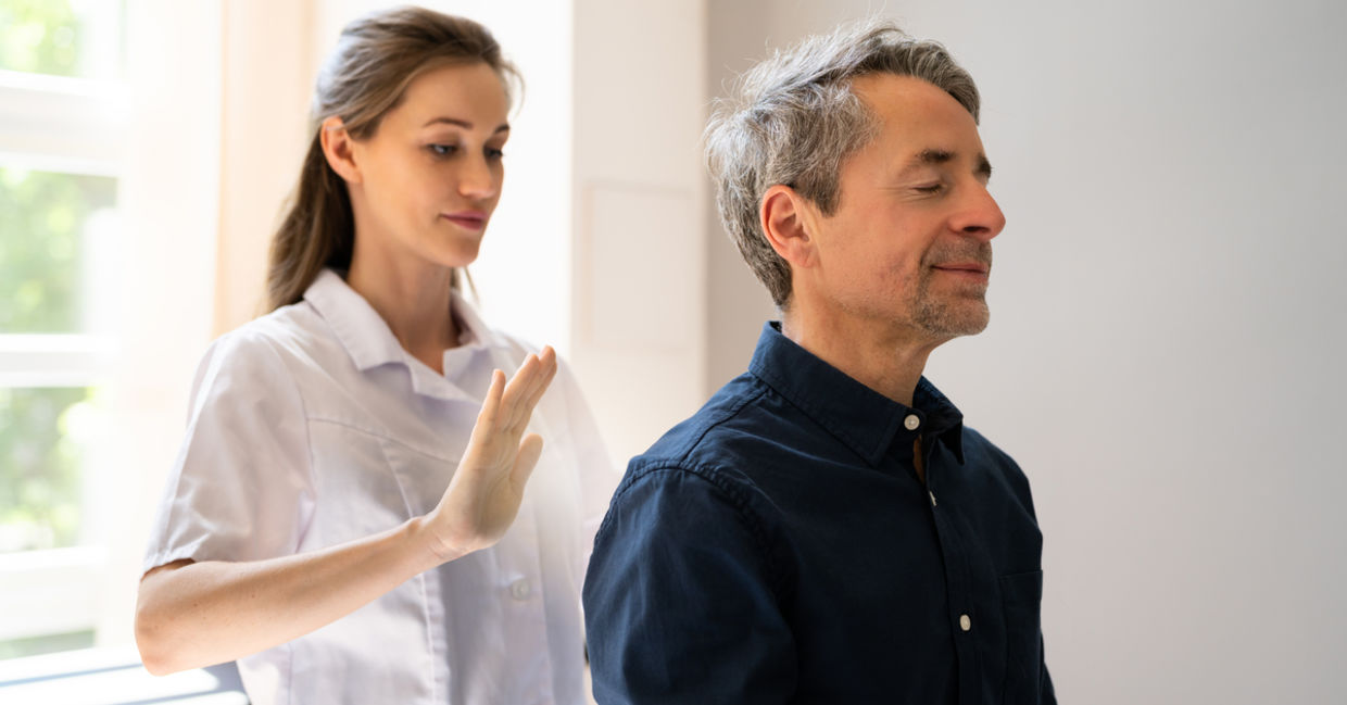 A man receives a healing reiki treatment.