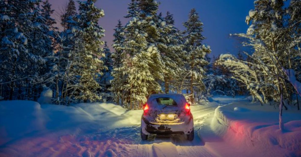 Car traveling on a snowy road.