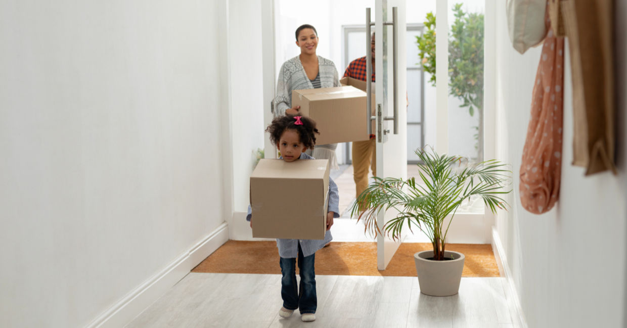Front view of happy family entering their new home.