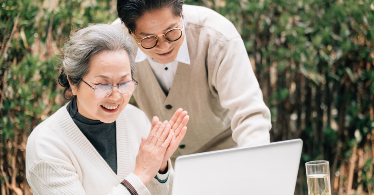 Senior couple using a laptop to code
