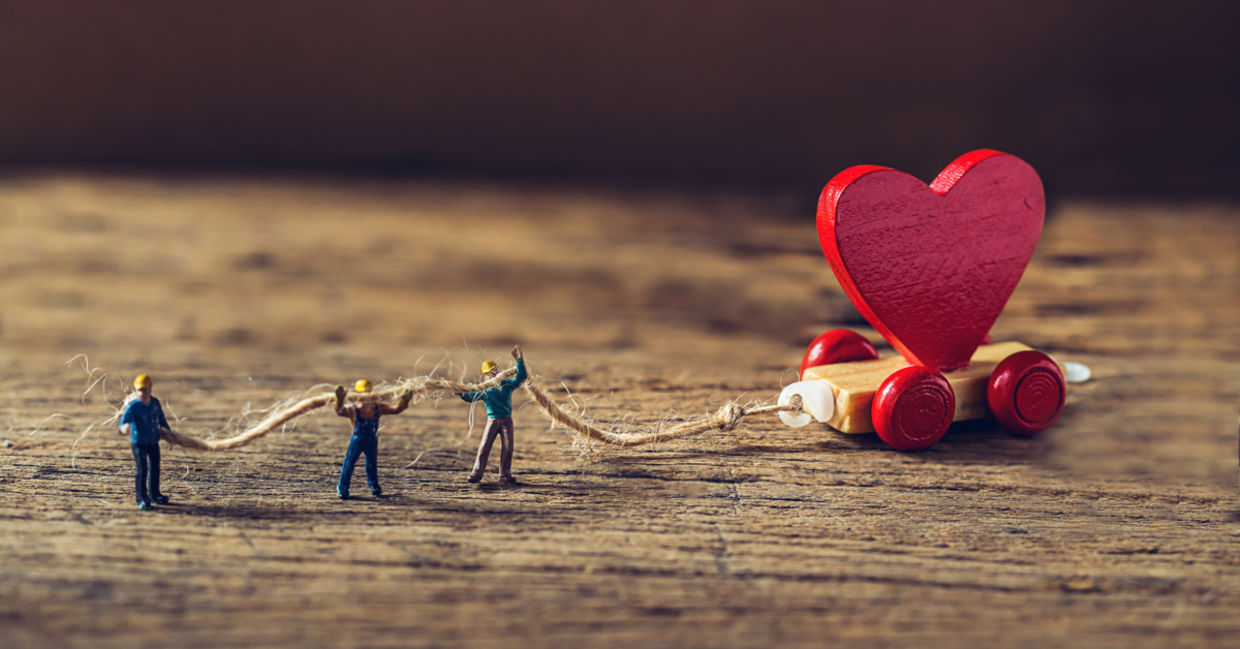 Towing a miniature red heart representing starting small with good deeds.