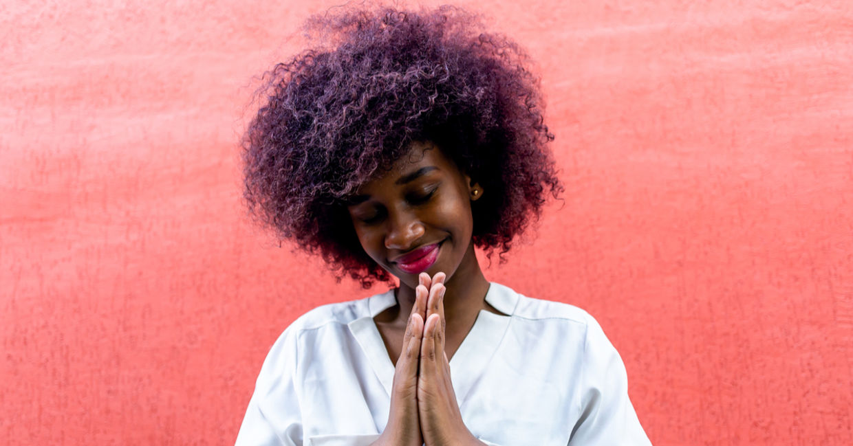 A young woman making a gesture of gratitude