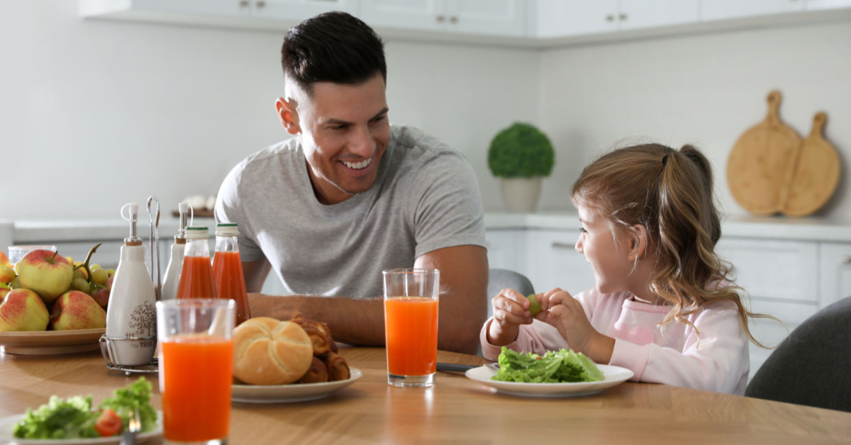 Father and daughter enjoying a healthy breakfast together.
