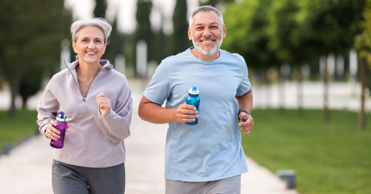Couple jogging in city park.