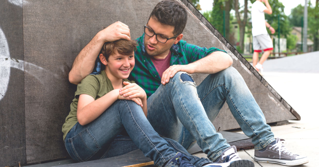 Father and son discussing life in the skate park.