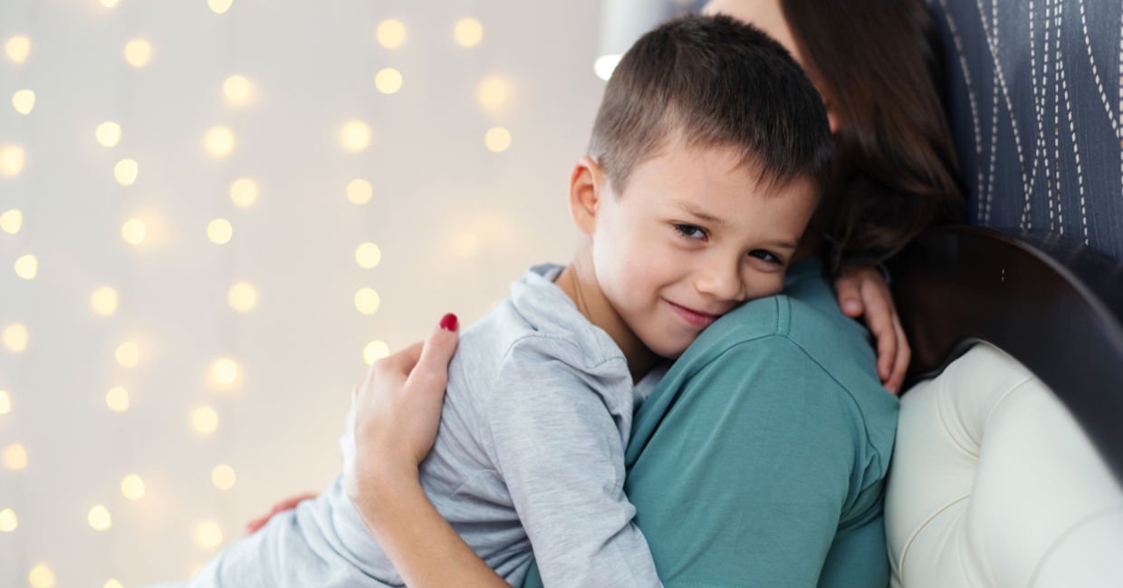 Boy hugging his mom.