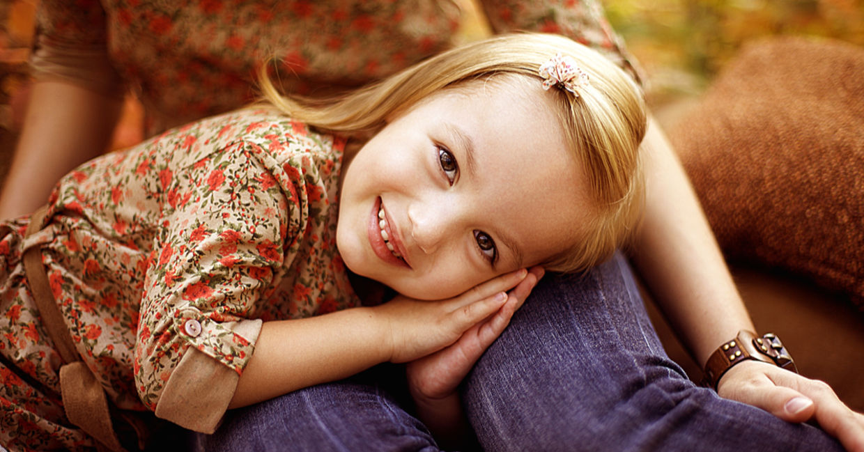 Little girl with her mother outdoors in the autumn.