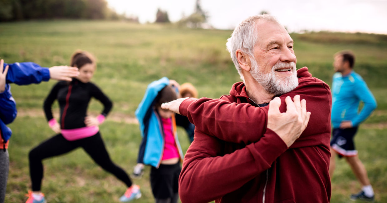 A group of people exercise outdoors, a great way to trigger mitochondrial biogenesis.