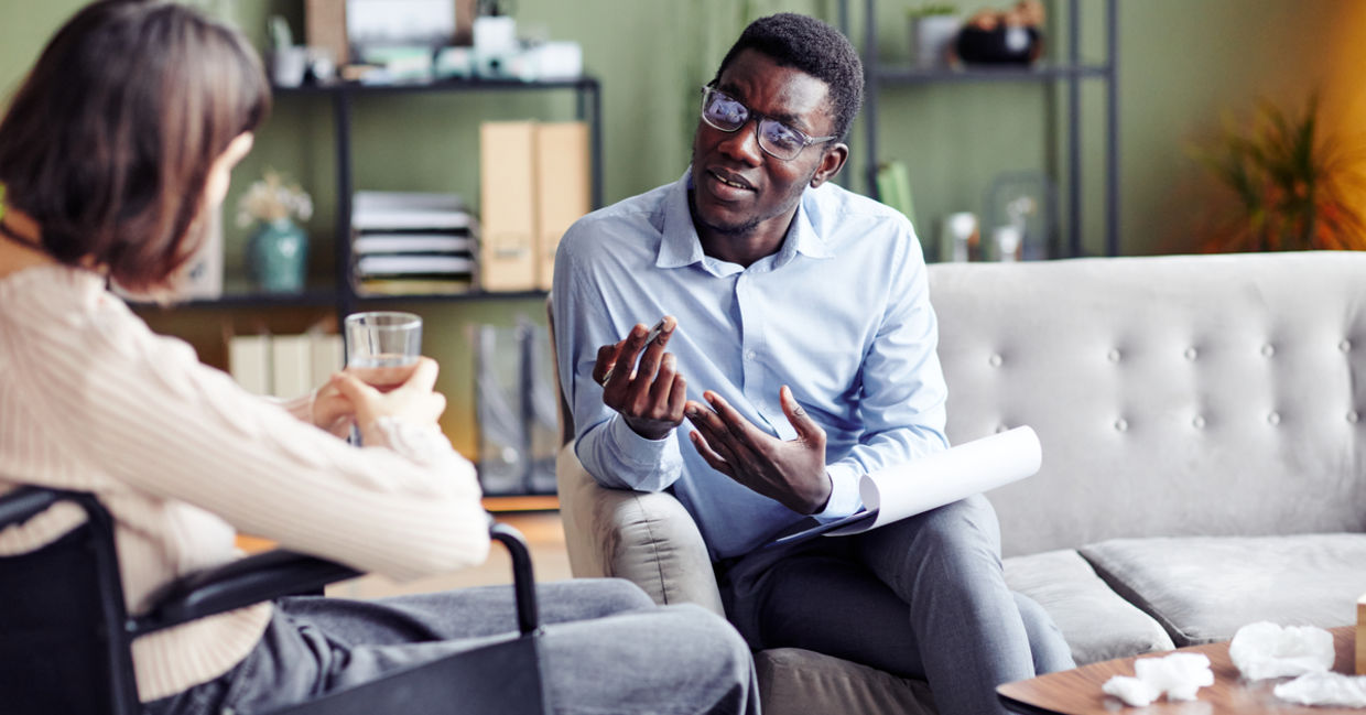 Psychologist teaching young woman stress management and other coping skills.