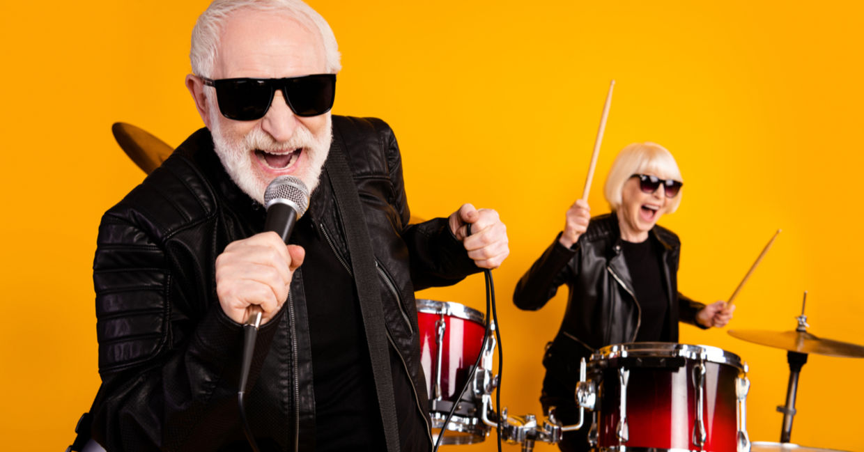Portrait of cheerful seniors enjoying playing music.
