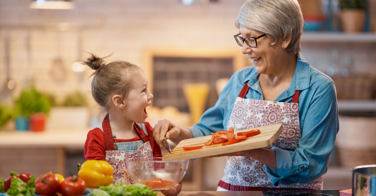 A grandma conveys love to her granddaughter as they cook together, an act of tsavd tanem.
