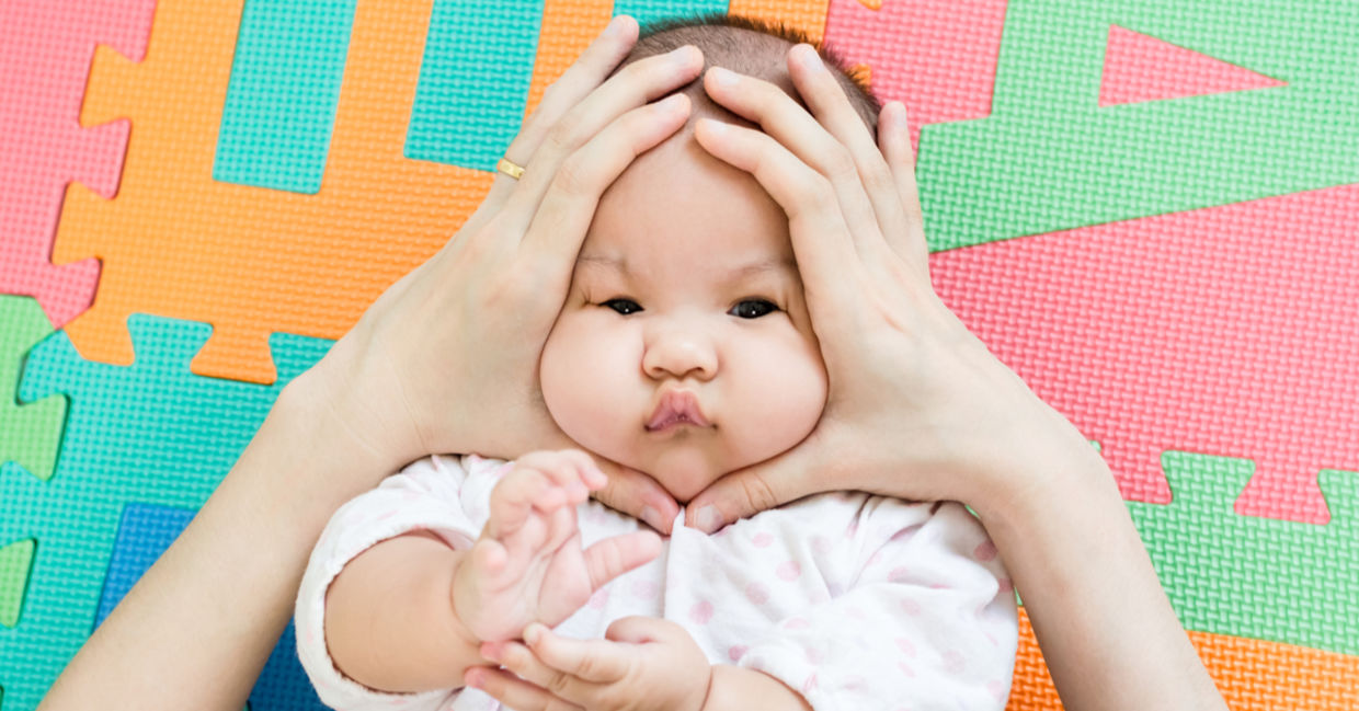 A mother squeezes her cuddly baby, gemes-style.