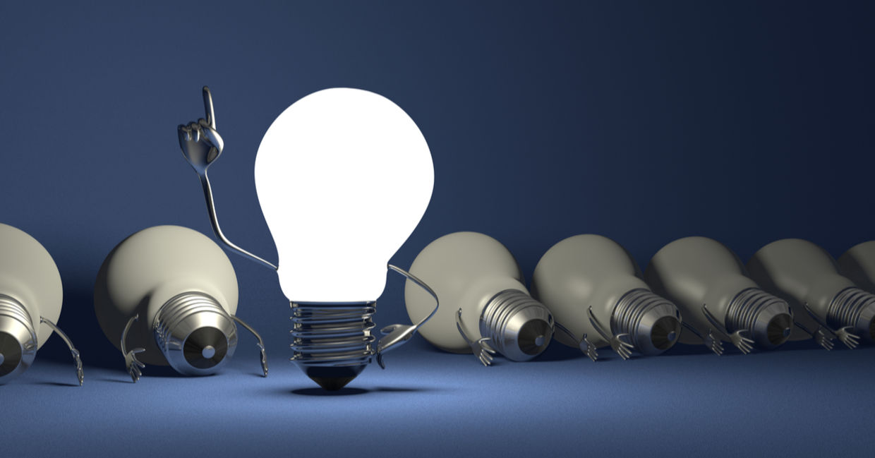 Glowing light bulb character in moment of insight.