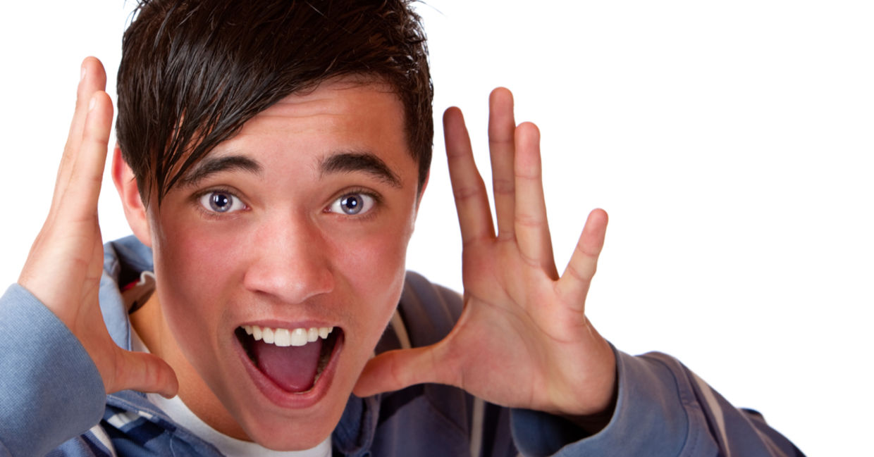 Teen holding his hands by his head and announcing interesting news.