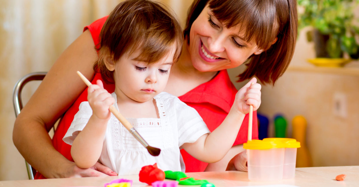 Mom and daughter painting together.