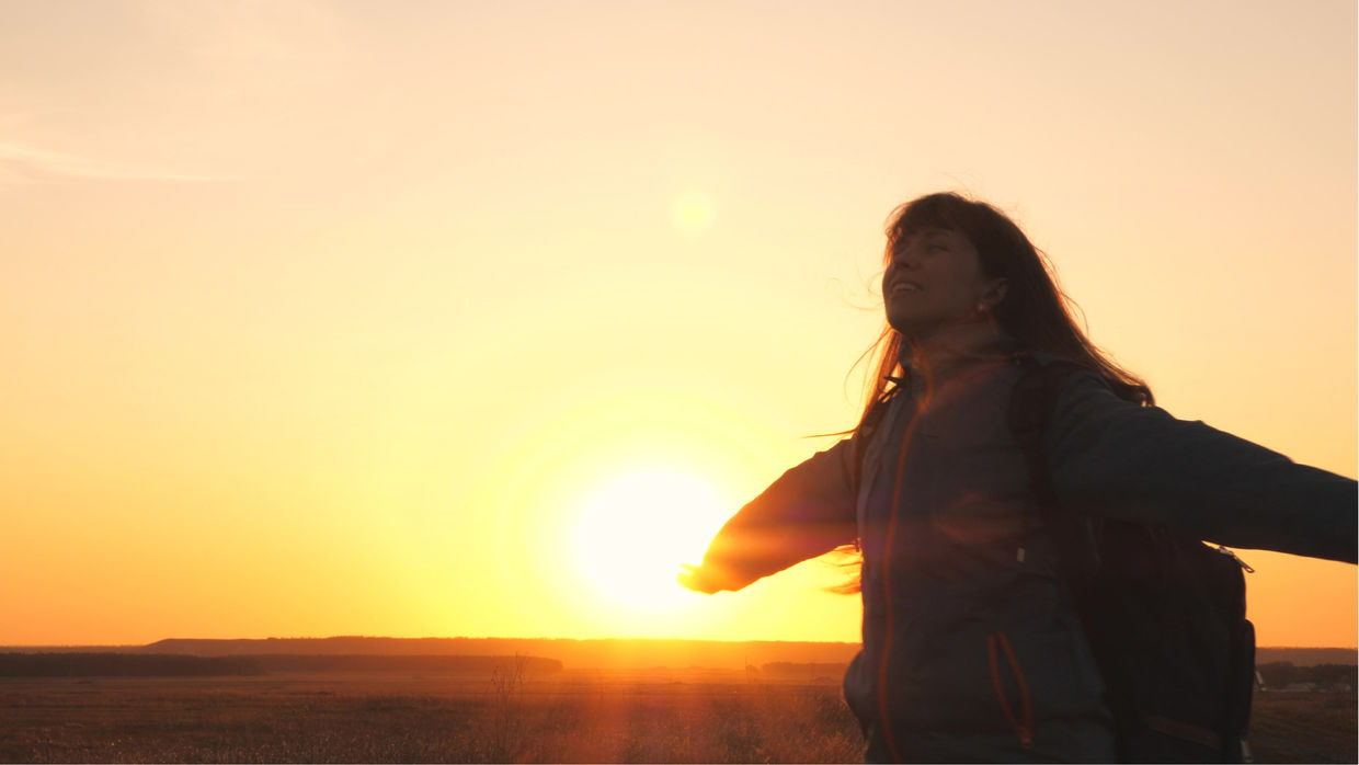 A happy girl closes her eyes.