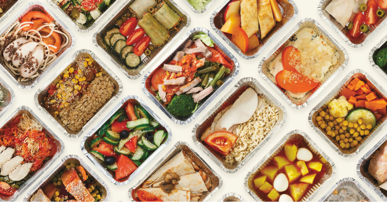 Restaurant food is wrapped in foil tins, ready for doggie bags.