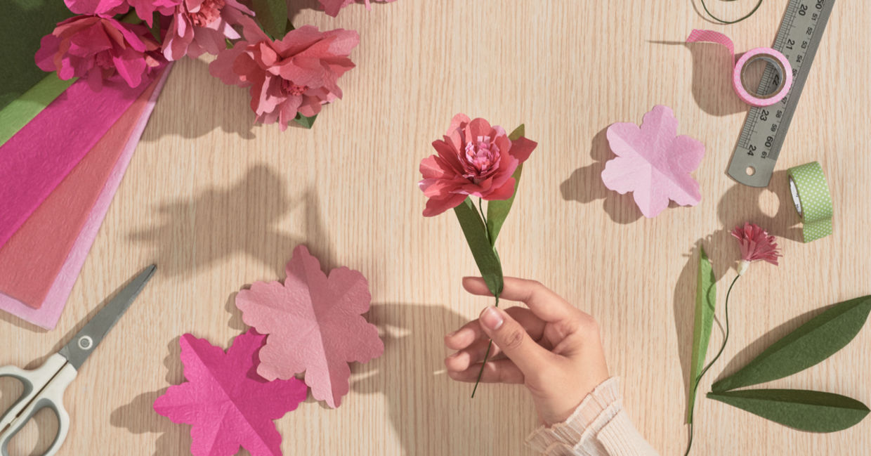 A girl holding a paper flower.