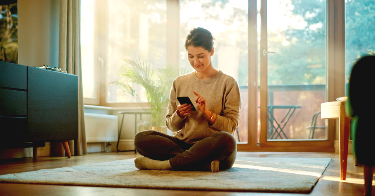 Smiling young woman using her phone to plan and be productive.