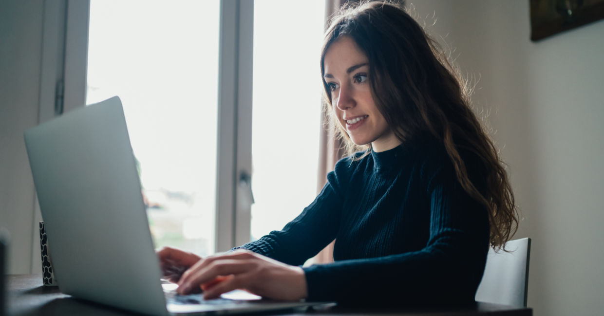 A young woman sitting with her laptop.