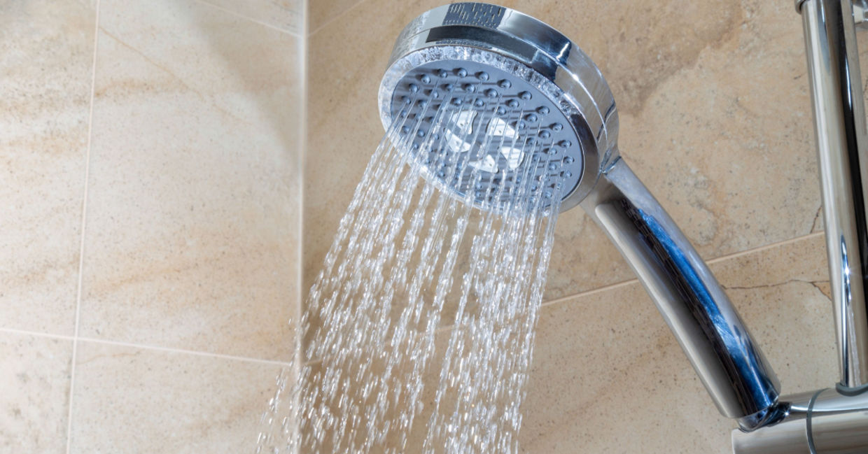 Running water from a shower faucet with a filter.