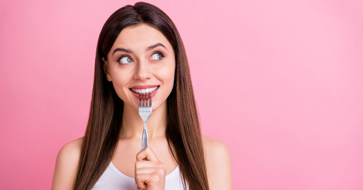 A young woman dreaming about food.