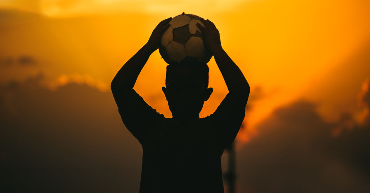A child holding a soccer ball.