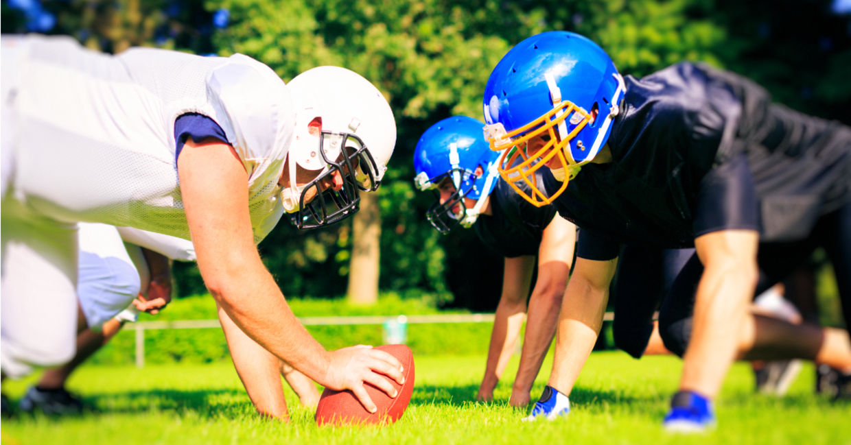 High school football players facing off.