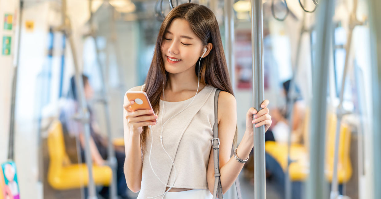Young passenger listening to music during her commute.