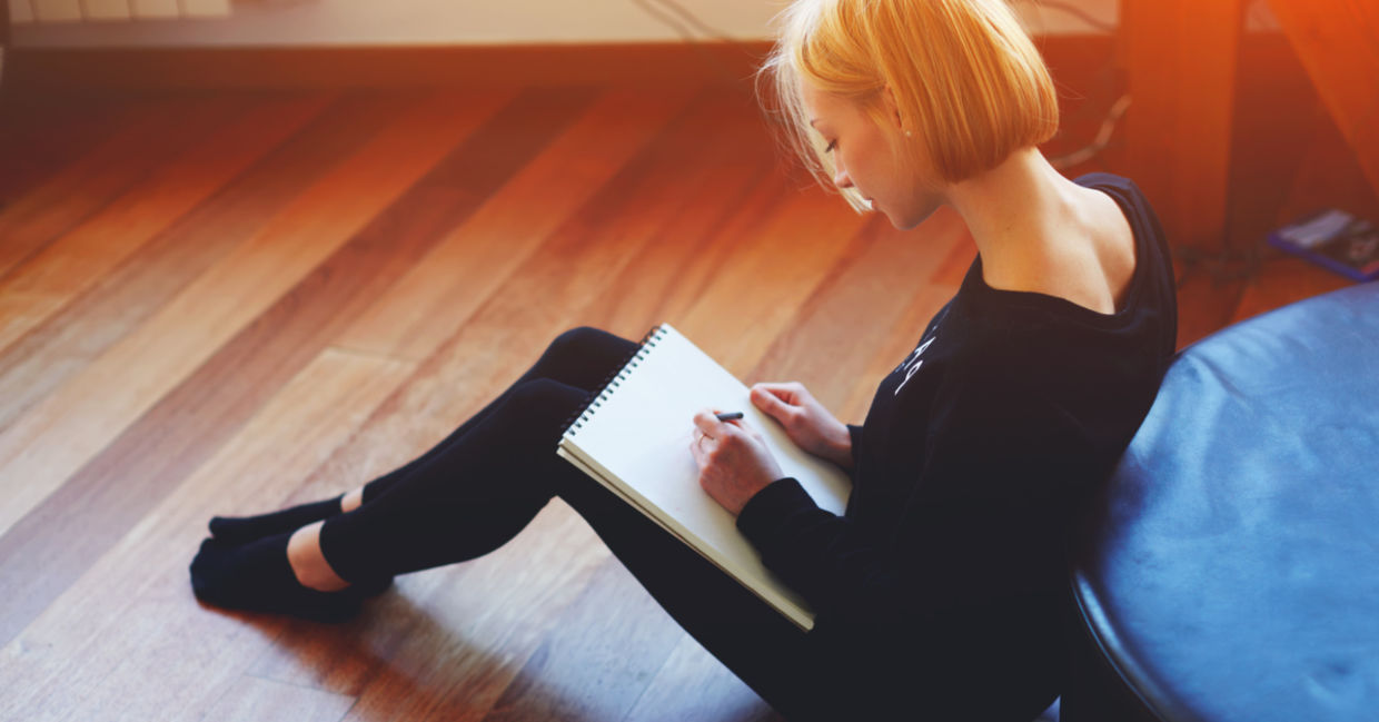 Woman sitting on wooden floor